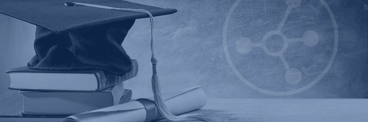 A stack of hardcover books topped by a graduation cap, beside a diploma scroll