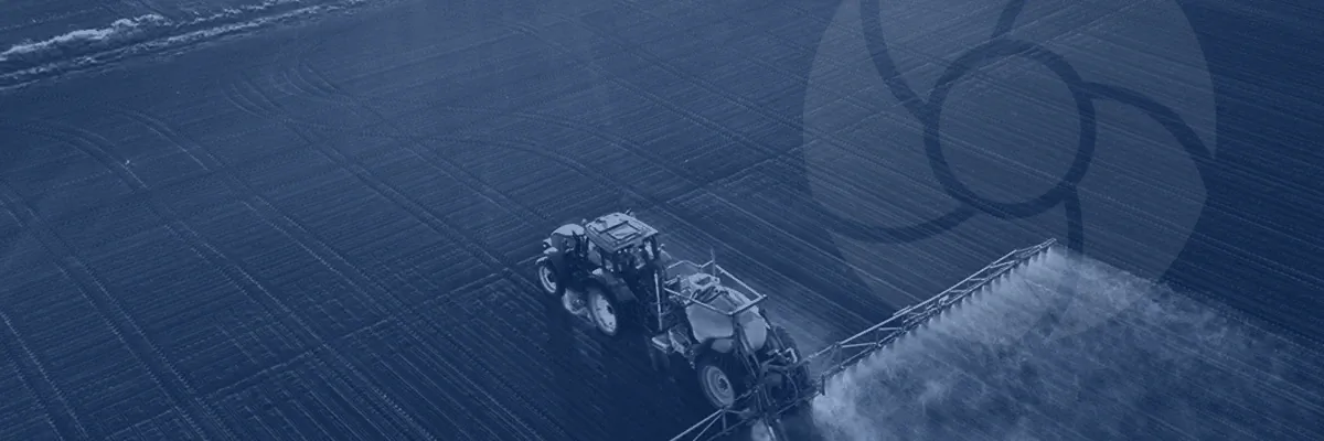 Tractor spraying in a field with a light logo overlay.